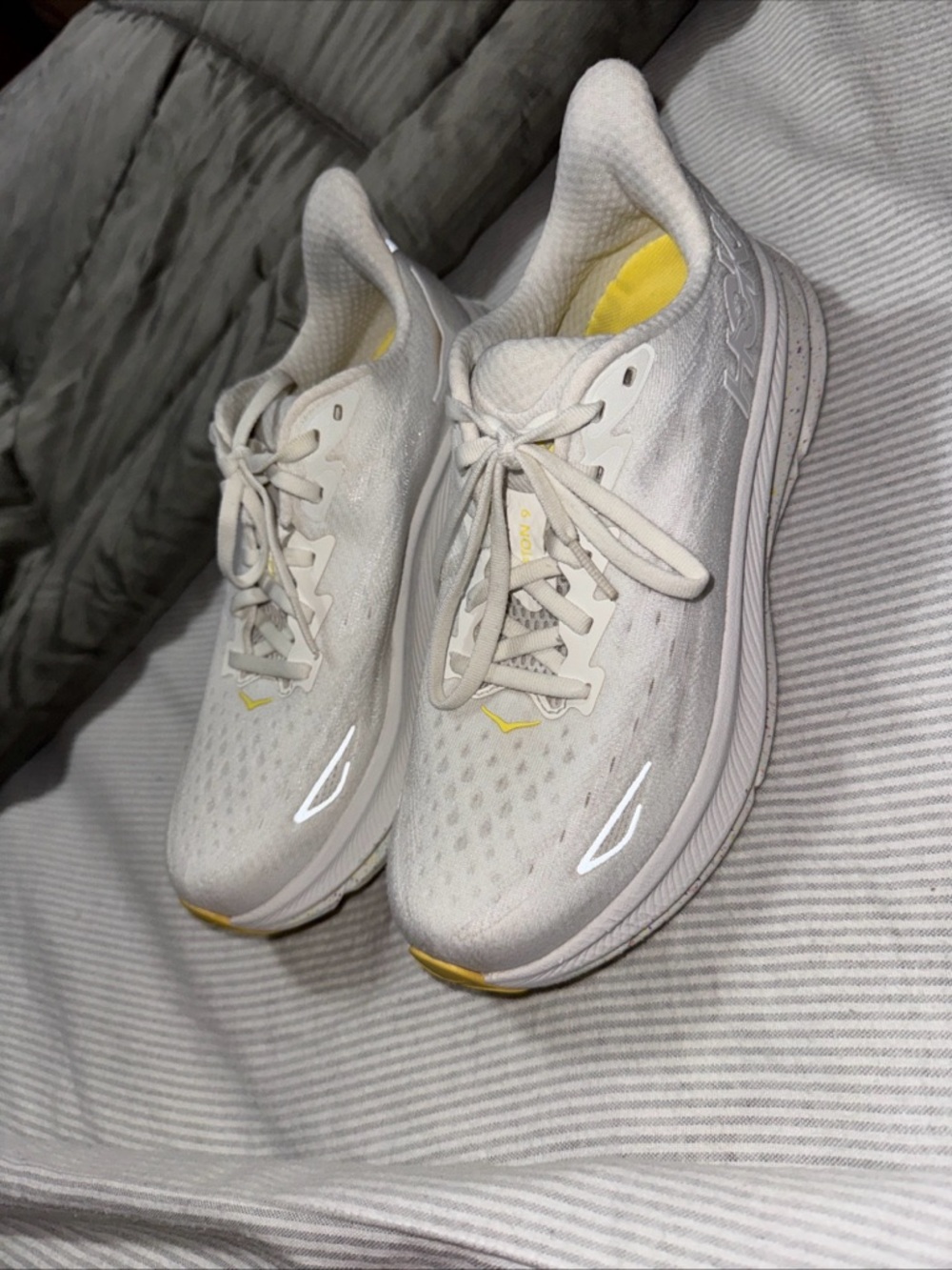 HOKA Clifton 9 running shoes in the "White / Lemonade" 8.5